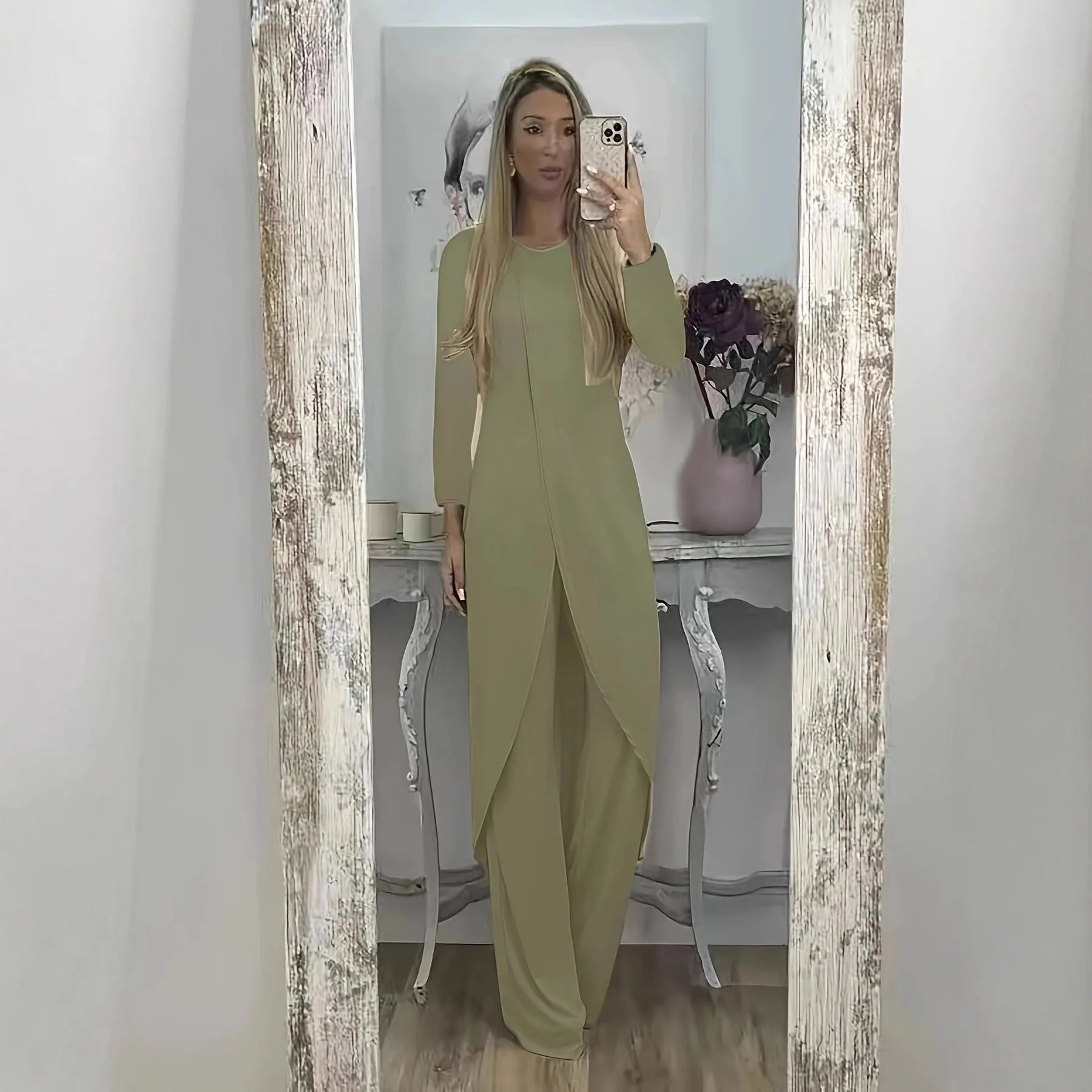 Women's black polyester two-piece lounge set with long sleeve top and loose trousers on a hanger.