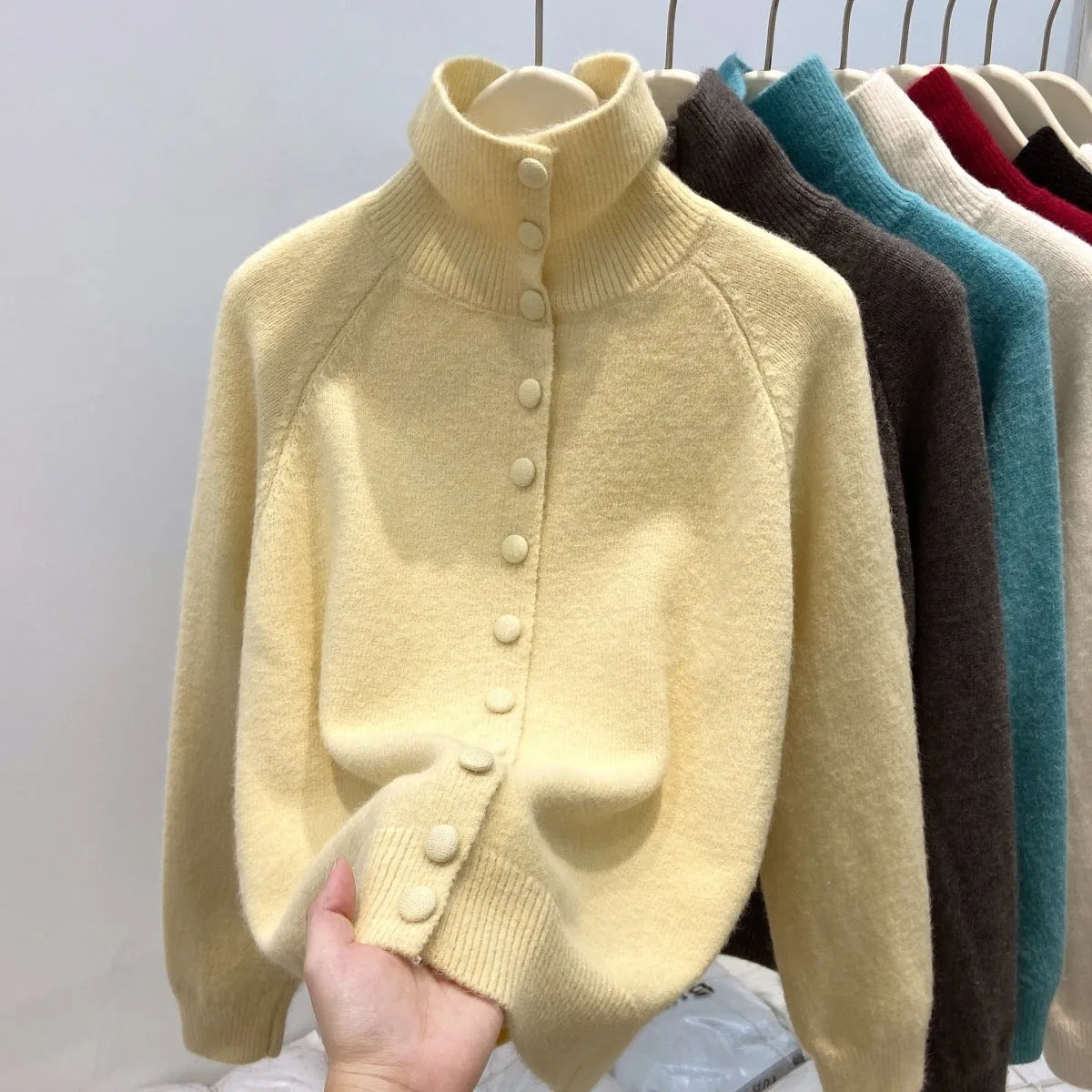 Women's loose fit turtleneck cardigan in thick polyester knit, button front, available in six colours including red and blue