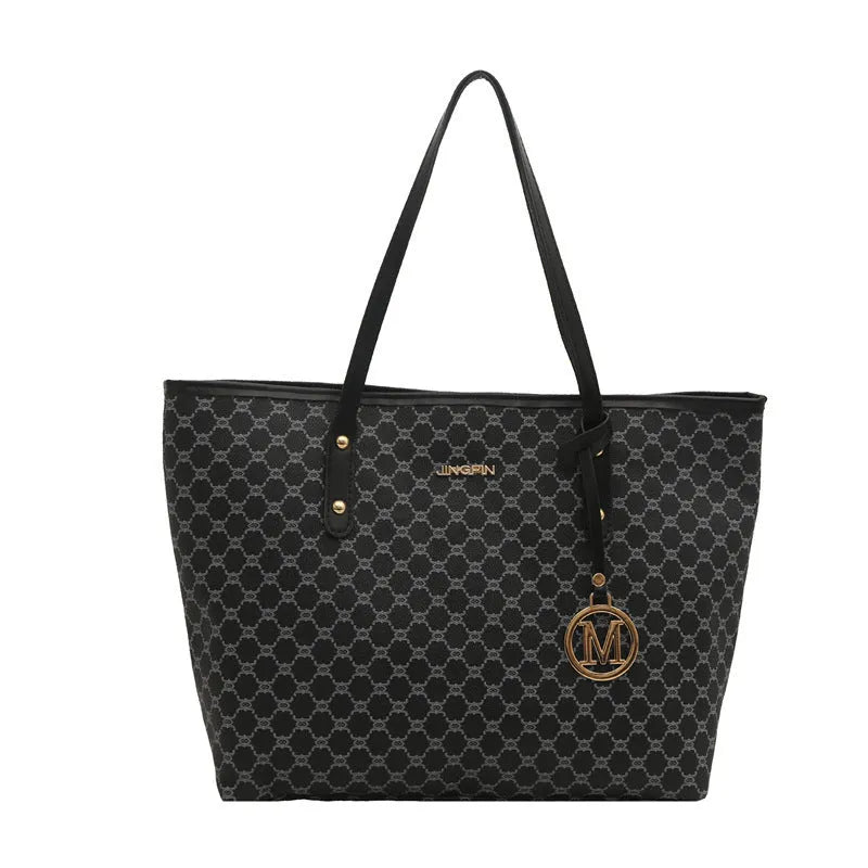 Structured black PU leather shoulder bag with adjustable strap and visible sewing thread detailing