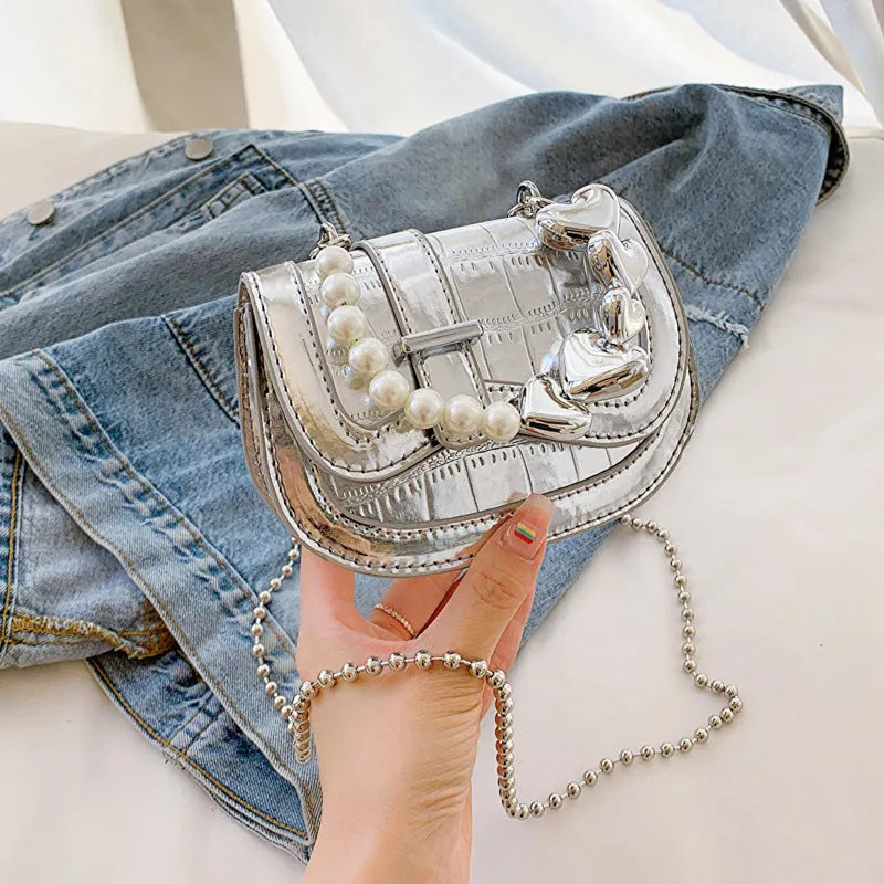 Silver PU leather women's crossbody bag with a horizontal square shape and single shoulder strap.