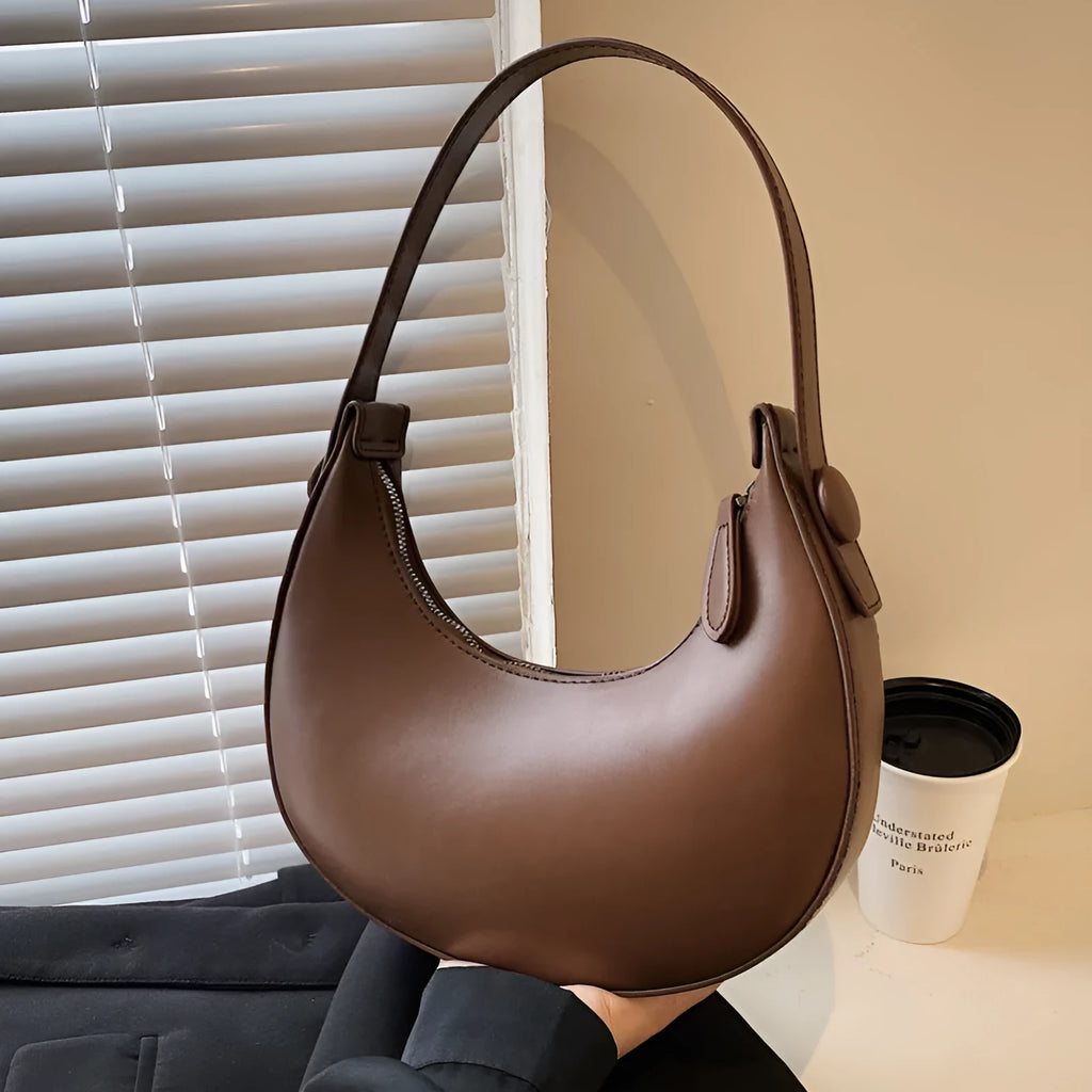 Women's retro-style PU shoulder bag in a dumpling shape, shown in cream yellow colour with a shoulder strap.