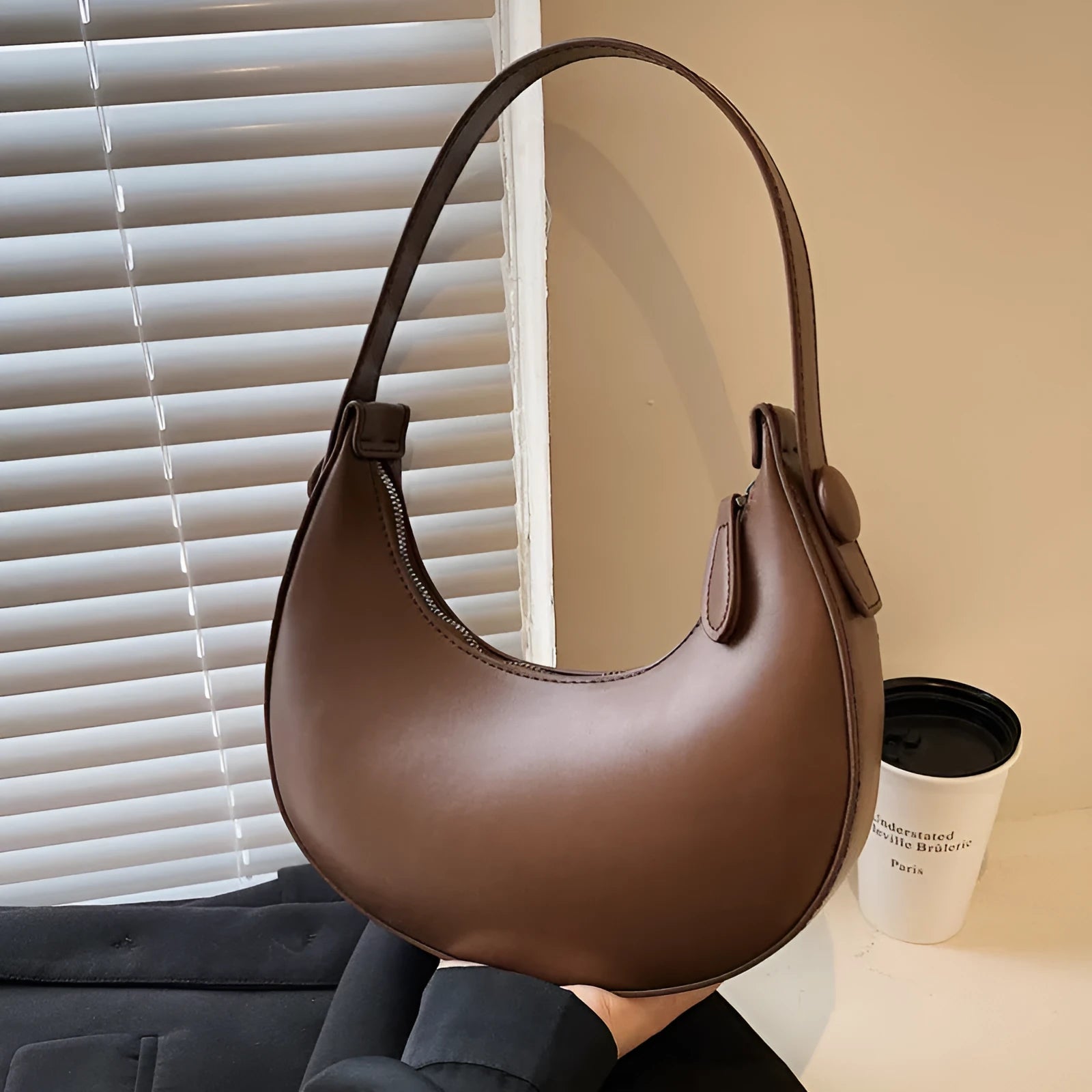 Women's retro-style PU shoulder bag in a dumpling shape, shown in cream yellow colour with a shoulder strap.