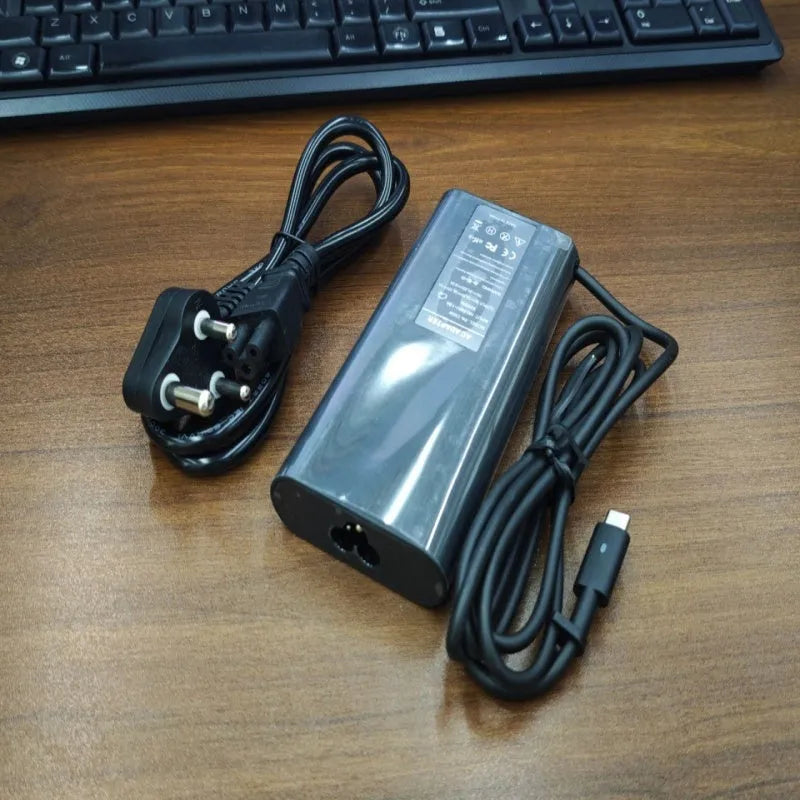 Black oval 65W Type-C laptop power adapter with international power cords