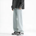 Men's light blue washed straight leg jeans with button waist closure on hanger