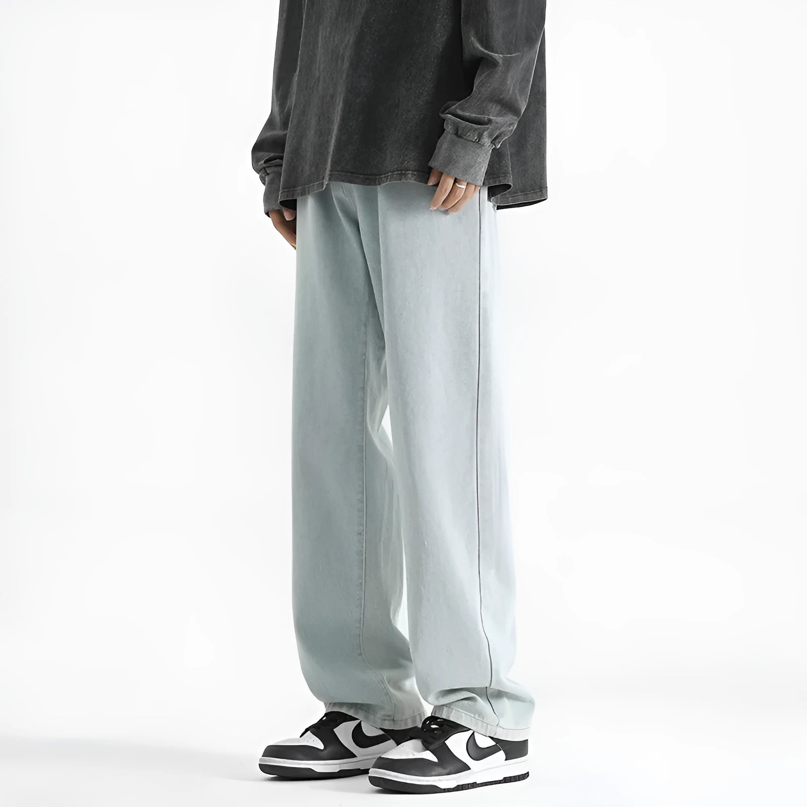 Men's light blue washed straight leg jeans with button waist closure on hanger