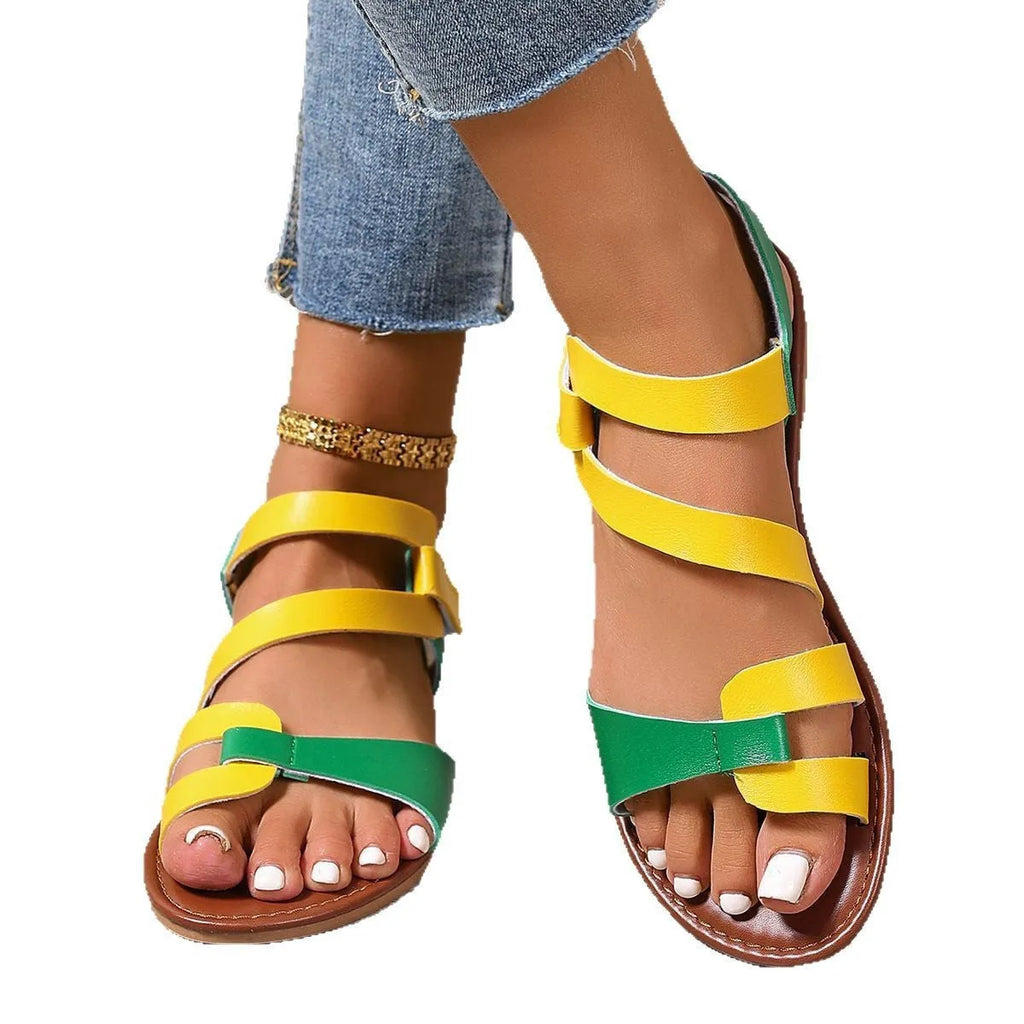 Women's flat sandals with Velcro strap, round toe, and rubber sole in black, brown, and multicolour.