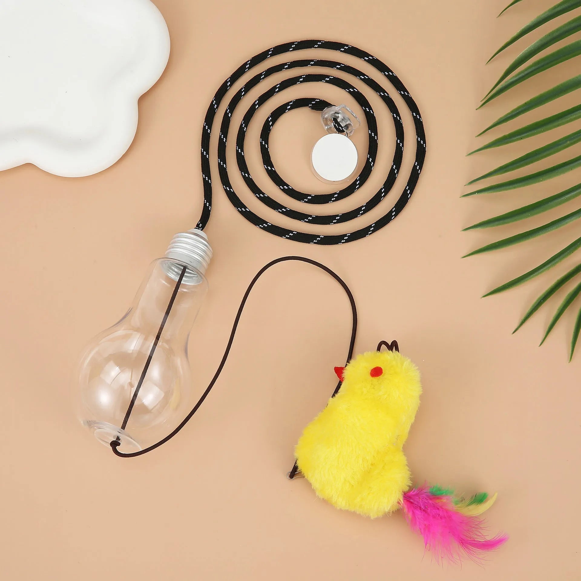 Grey and yellow interactive cat toy with swinging mouse, sound response, and treat dispenser on retractable cord
