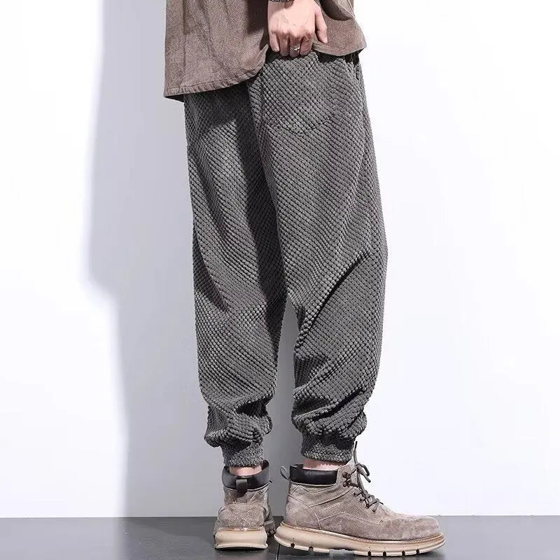 Men's grey straight-leg casual sweatpants with ankle strap detail on a hanger.