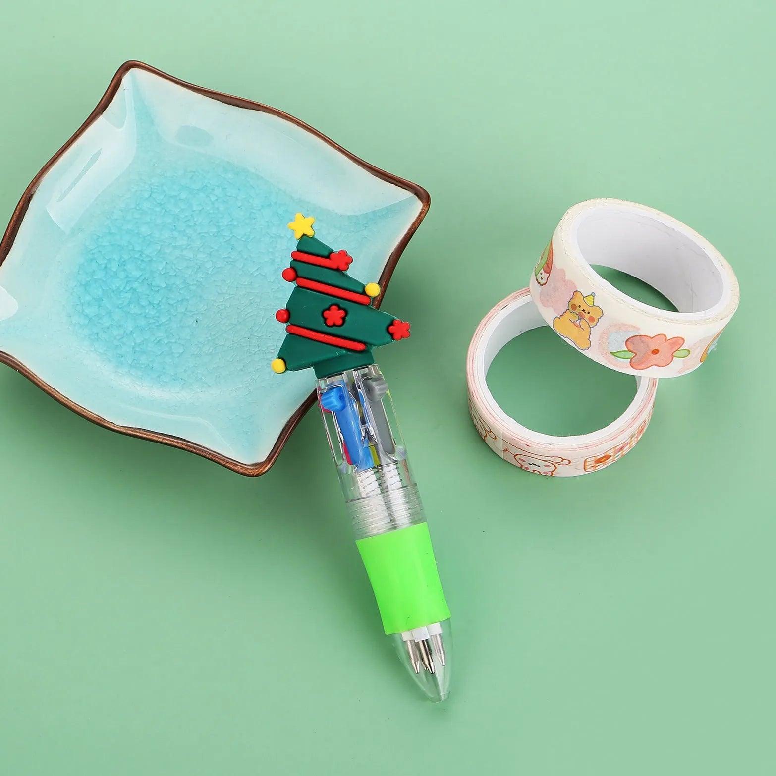 Christmas mini four-colour press-action ballpoint pen with festive designs measuring 11 cm.