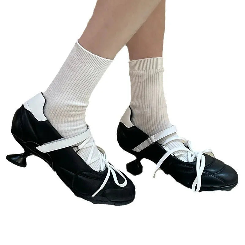 Women's silver lace-up bow sports shoes with a round toe and mid heel on a white background.