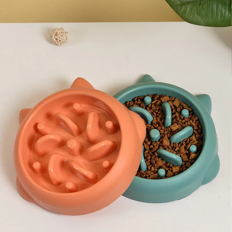 Green pet slow feeder bowl with raised internal ridges to slow eating for dogs and cats.