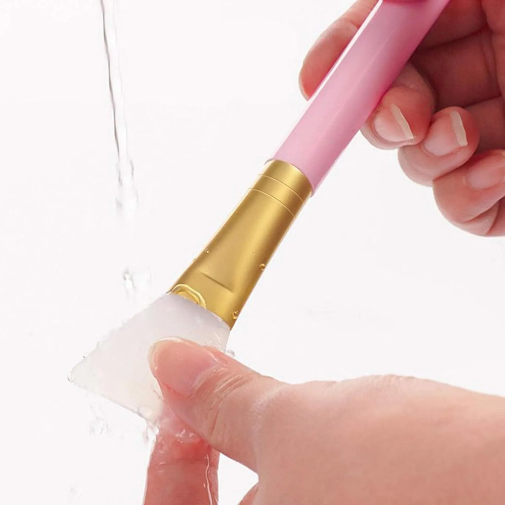 Reusable silicone spatula applicator for face and body masks in six colour options on a plain background.