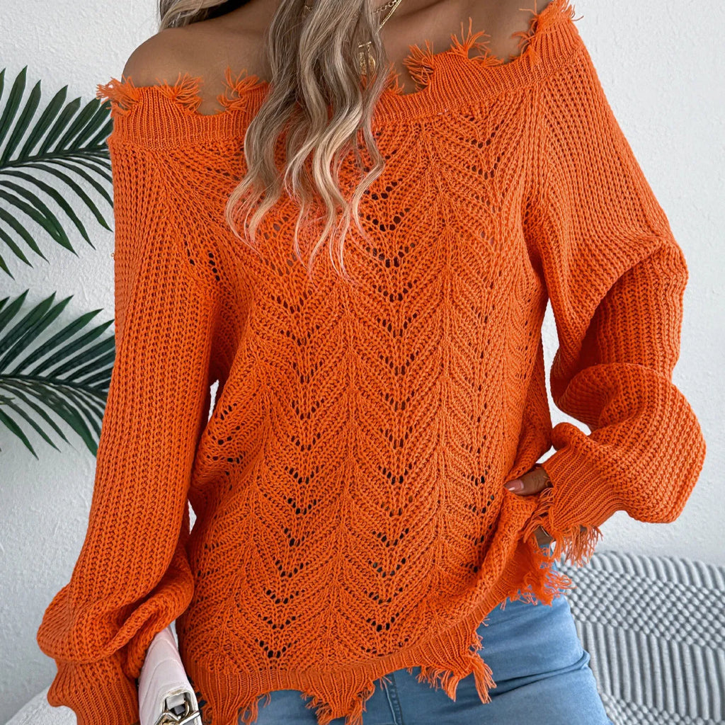White hollow-out patterned long-sleeved sweater with a cut off-the-shoulder neckline on a model.