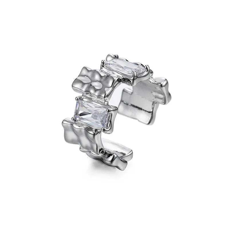 Geometric cross zircon ring with silver plating and open gemstone setting showing three-dimensional decoration
