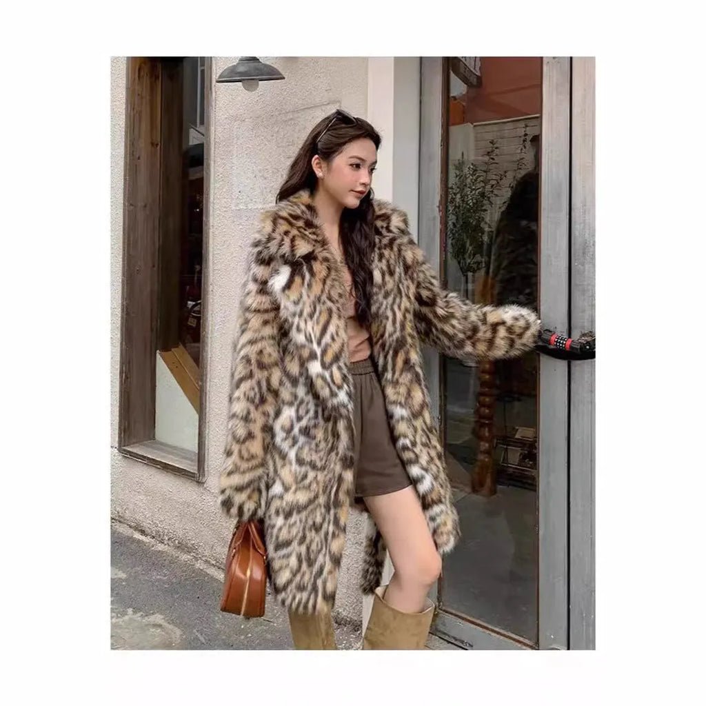Women's grey faux fur mid-length winter coat with a fur collar and pockets on a model.