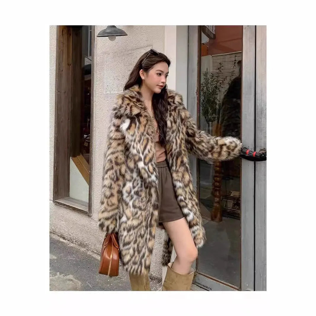 Women's grey faux fur mid-length winter coat with a fur collar and pockets on a model.
