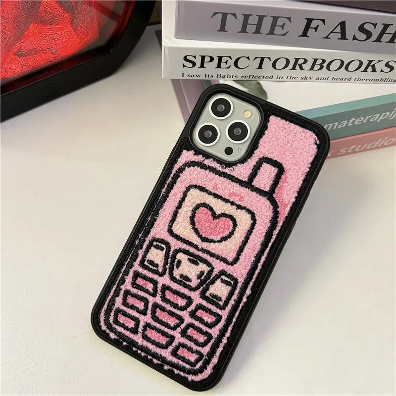 Pink TPU iPhone case with a textured towel-embroidered back cover, shown fitting an iPhone.