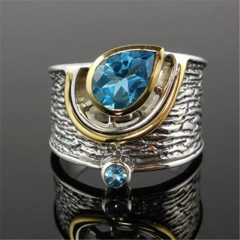 Blue zircon drop shape ring with Chinese-inspired design in alloy setting
