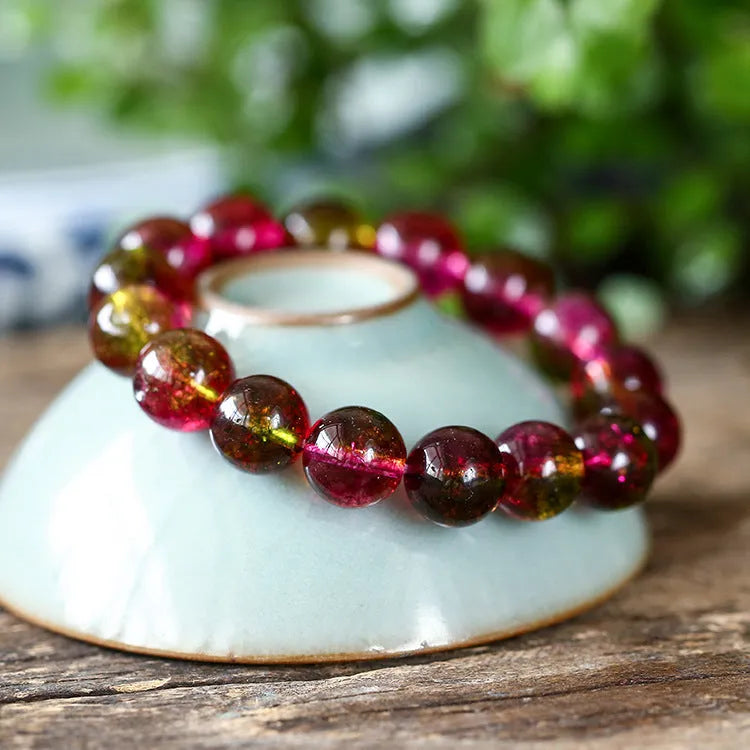 Handmade watermelon crystal bracelet showing pastoral design details on a wrist.