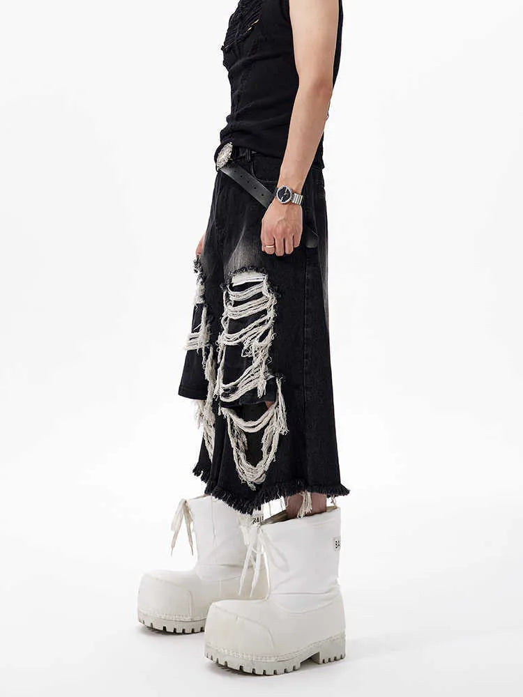 Women's black cropped wide leg jeans with ripped patch details and mid-high waist