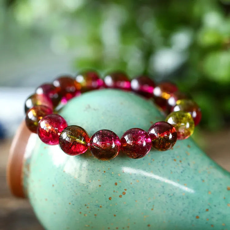 Handmade watermelon crystal bracelet showing pastoral design details on a wrist.