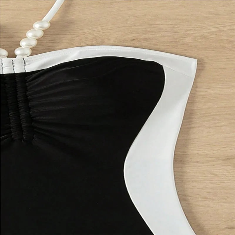 Women's black and white one-piece swimsuit with pearl spaghetti straps for swimming