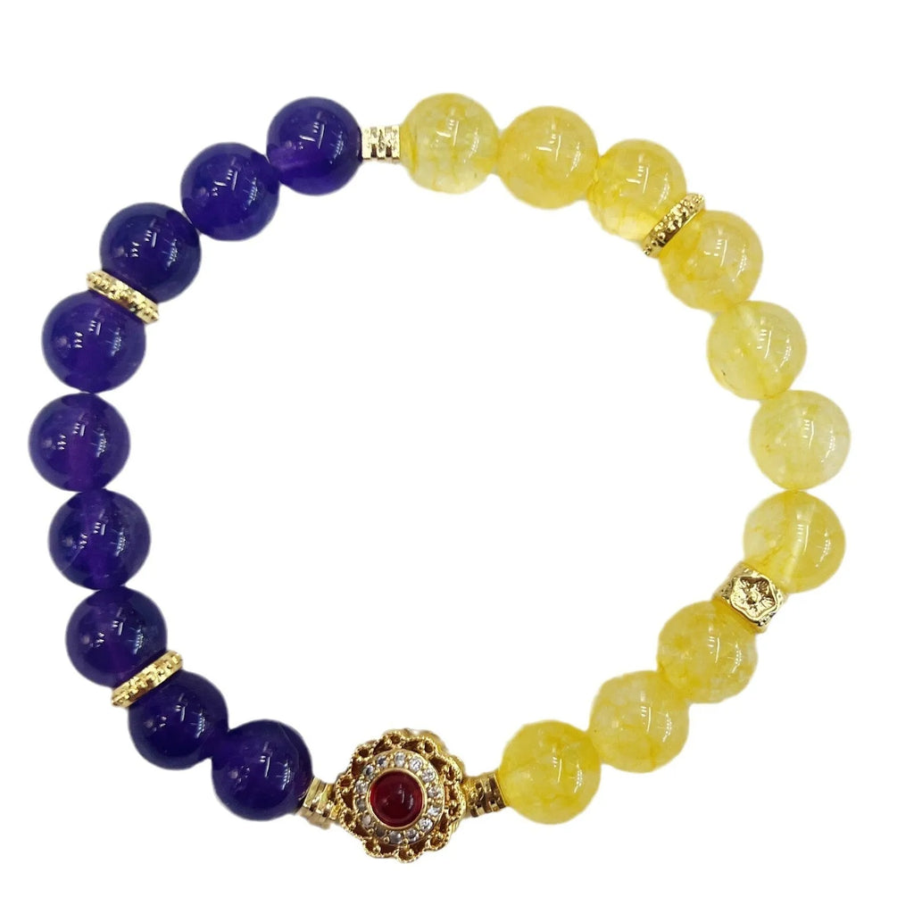 Handmade yellow and purple crystal bracelet for women on a wrist.