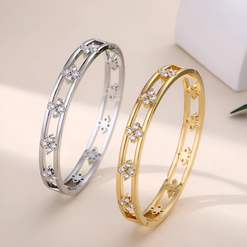 Gold and silver hollow women's bracelets with inlaid zircon stones and four-leaf clover designs.