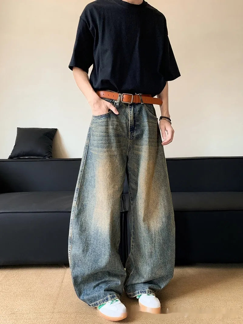 Men's retro blue distressed denim jeans with a wide-leg slim fit and micro elasticity.