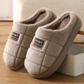 Men's grey and brown plaid rabbit hair slippers with thick wool lining and a flat EVA sole.