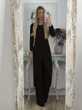 Women's black polyester two-piece lounge set with long sleeve top and loose trousers on a hanger.