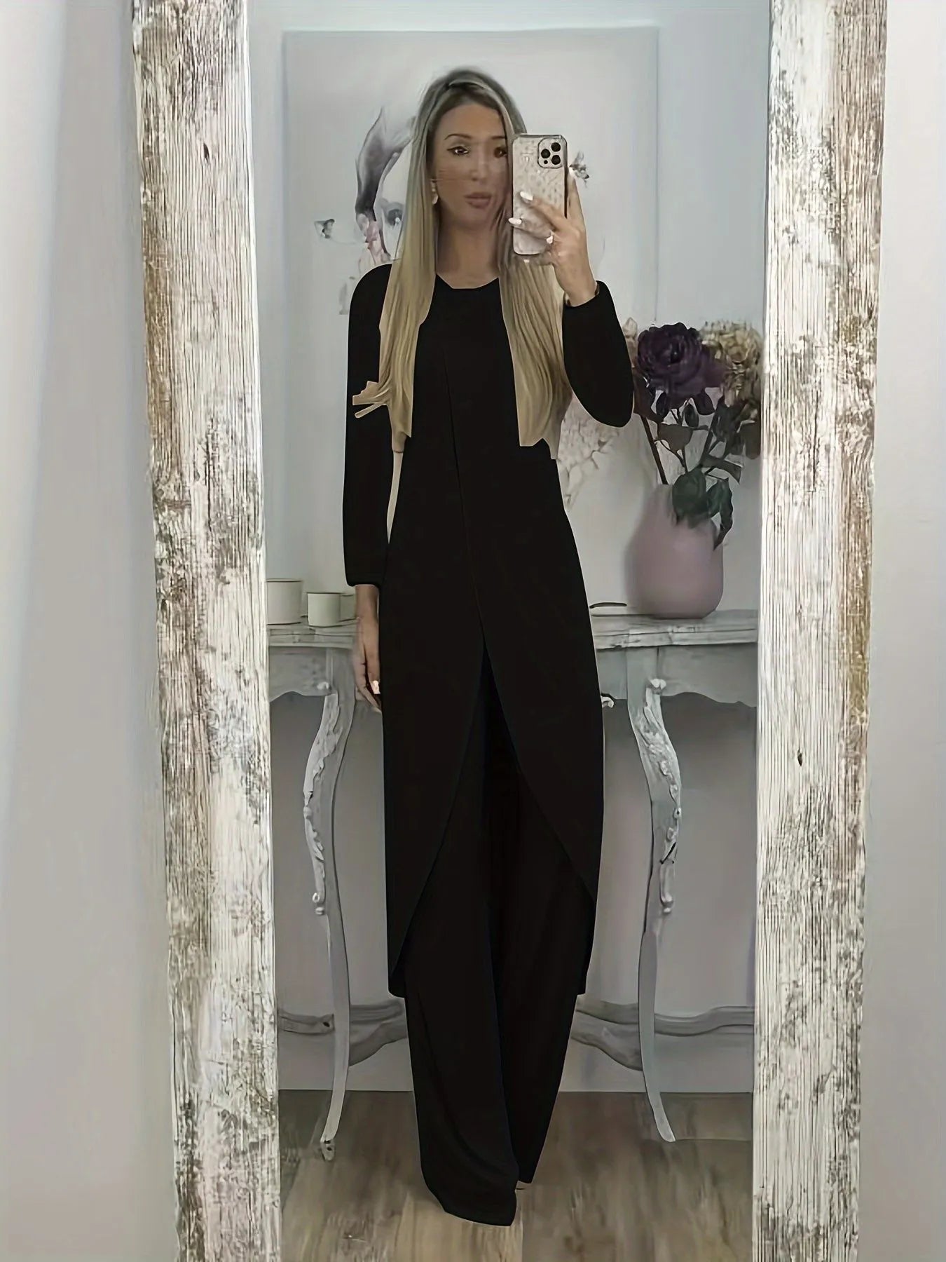 Women's black polyester two-piece lounge set with long sleeve top and loose trousers on a hanger.