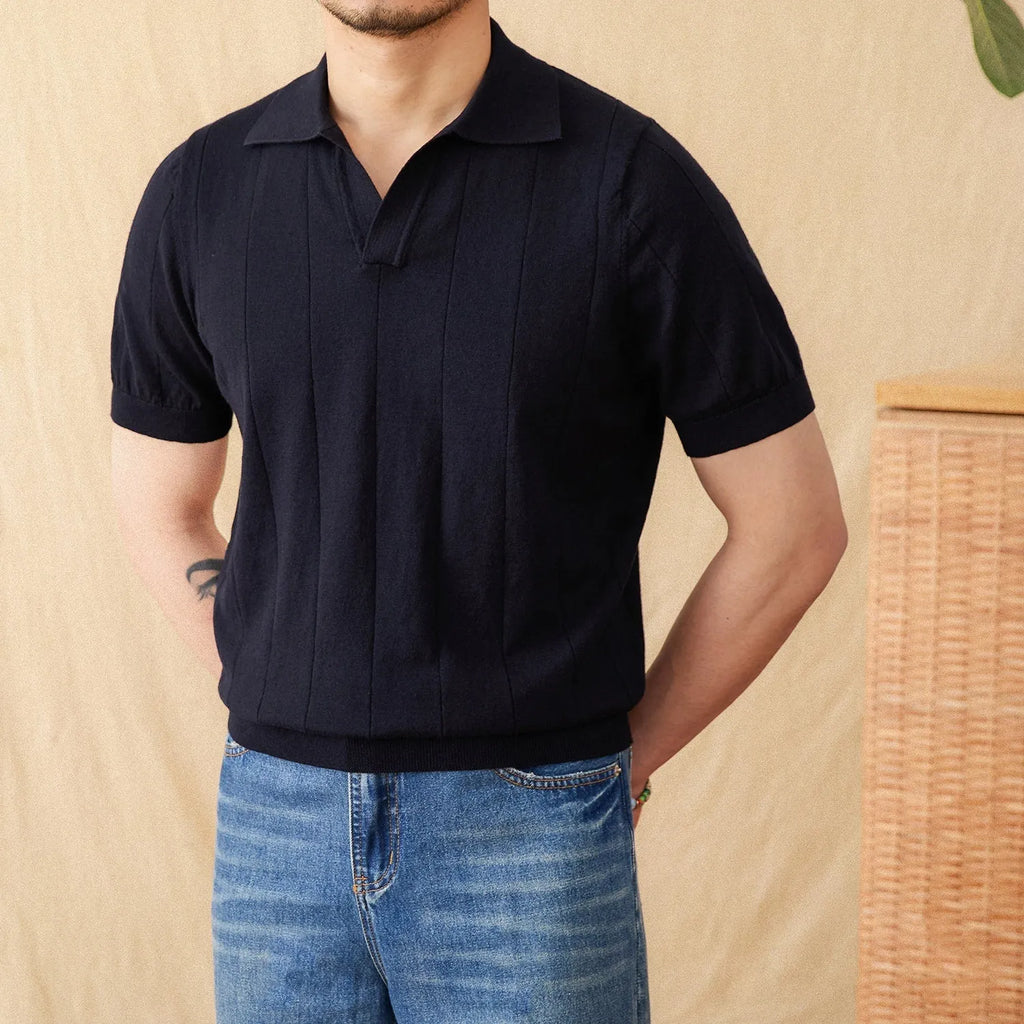 Knitted short sleeve polo collar top with sunken stripe pattern in dark blue.