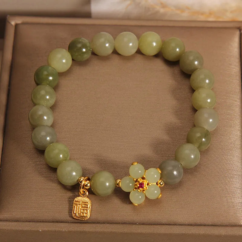 A grey jade and alloy casual bracelet for women, showing its unique design.