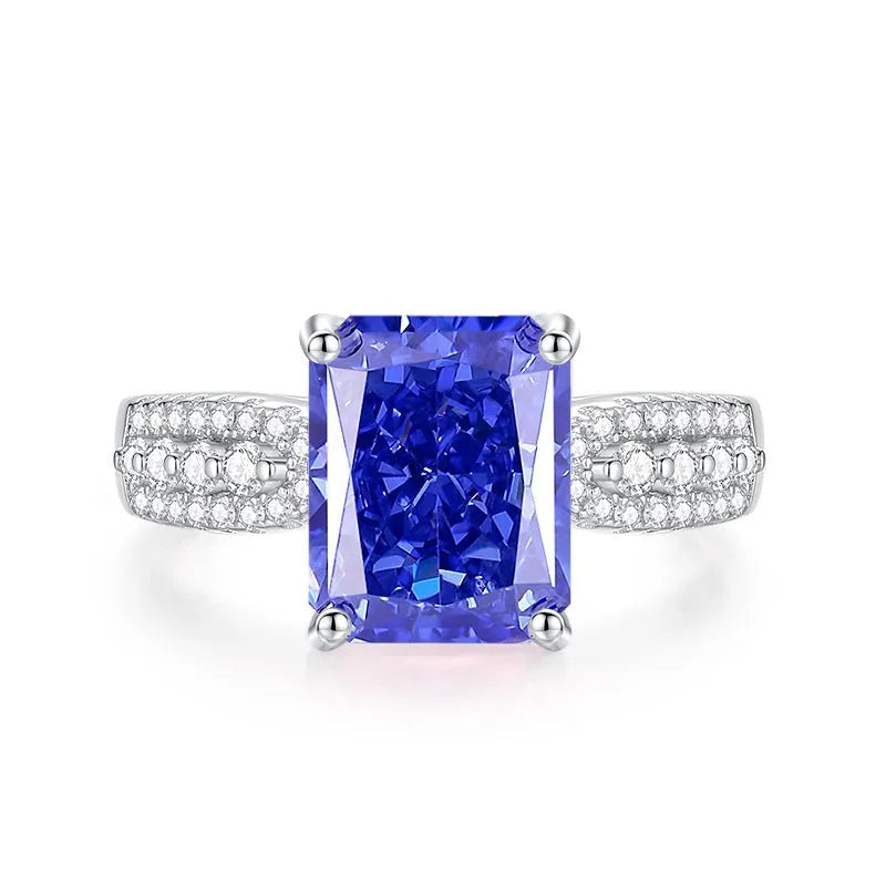 Heart-shaped 925 sterling silver ring with a sparkling ice flower cut colour zircon stone on a finger.
