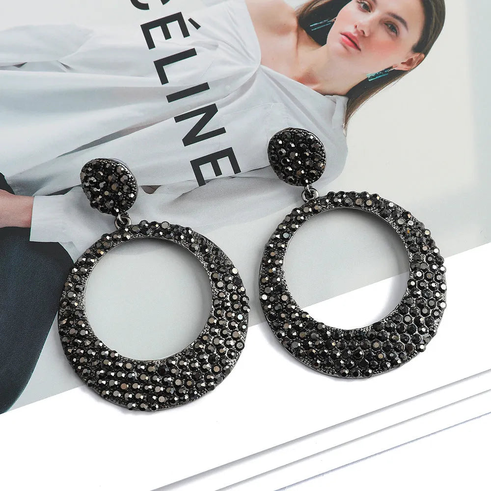 A pair of large round colourful metal pendant earrings in a cartoon style for women.