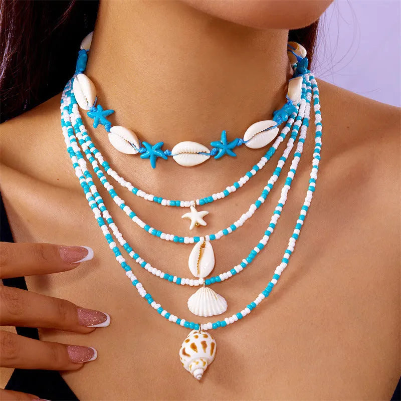 Women's multi-layer necklace set with starfish, shell and conch bead pendants in blue