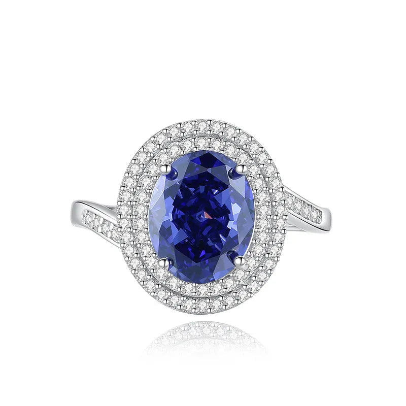 Heart-shaped 925 sterling silver ring with a sparkling ice flower cut colour zircon stone on a finger.