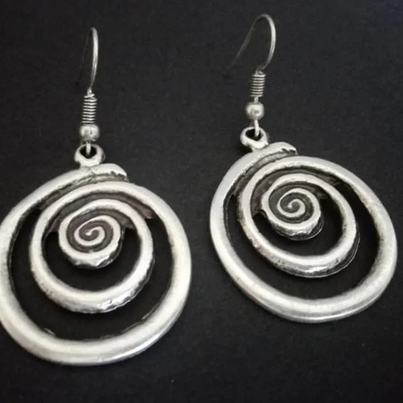 Silver geometric spiral distressed earrings measuring 2.6cm by 5cm with alloy construction