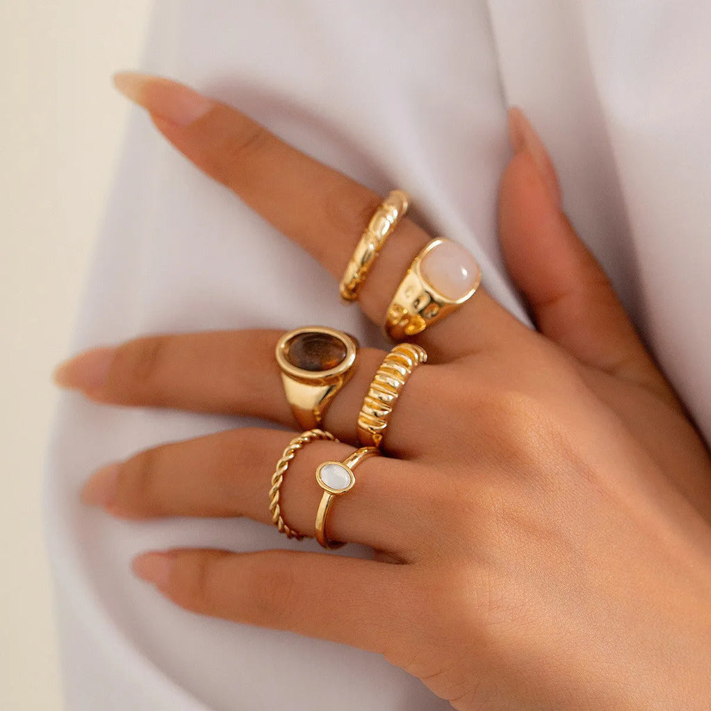 Set of six light gold geometric alloy rings with irregular shapes and electroplated finish