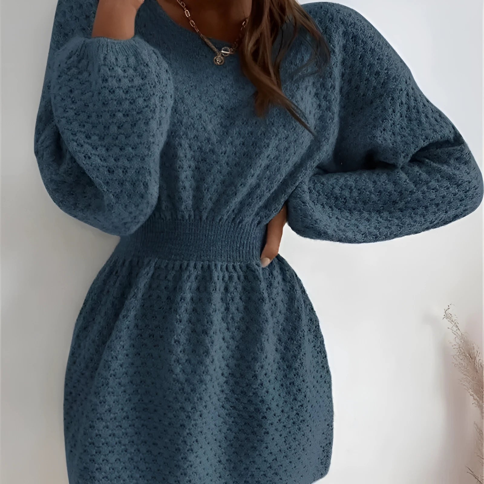 Blue polyester knitted dress with hand-crocheted flowers, fitted waist, and long sleeves