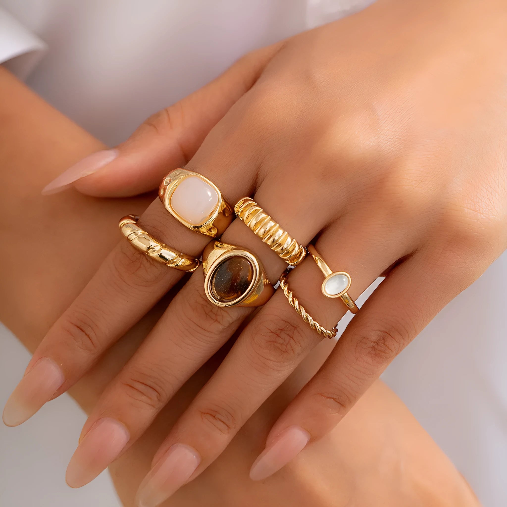 Set of six light gold geometric alloy rings with irregular shapes and electroplated finish