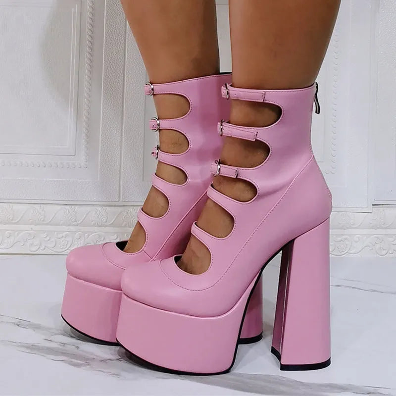 Women's black patent leather platform high heel boots with a thick heel and silver buckle fastening.