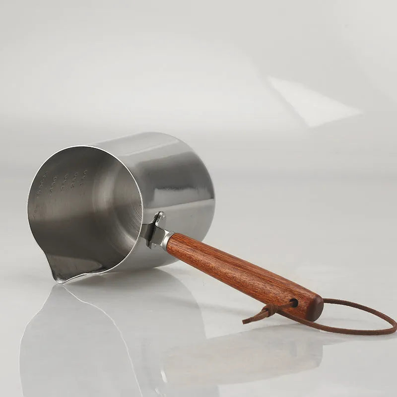 Stainless steel milk jug with wooden handle for latte art, shown in 350ml, 600ml and 1000ml sizes.