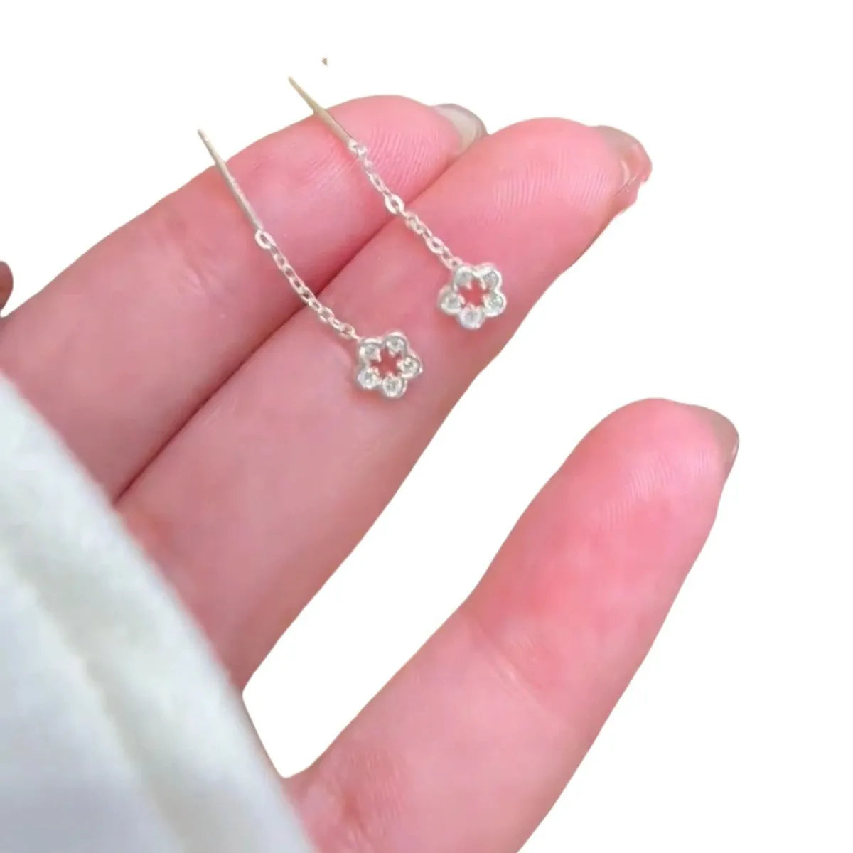 Silver colour hollow flower hanging earrings with petal design on alloy posts