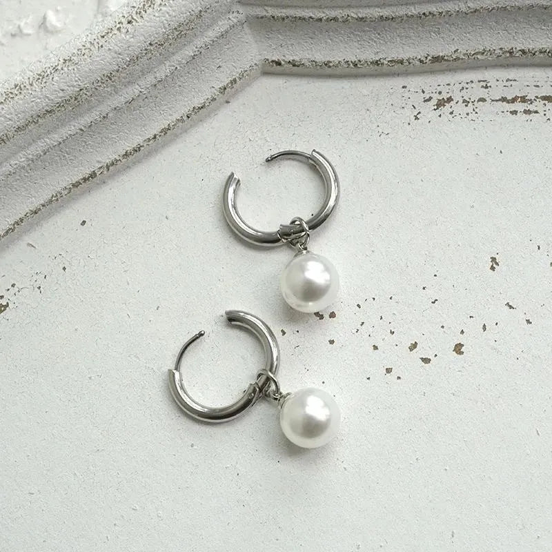 A pair of women's geometric drop earrings with a round pearl detail on alloy hooks.