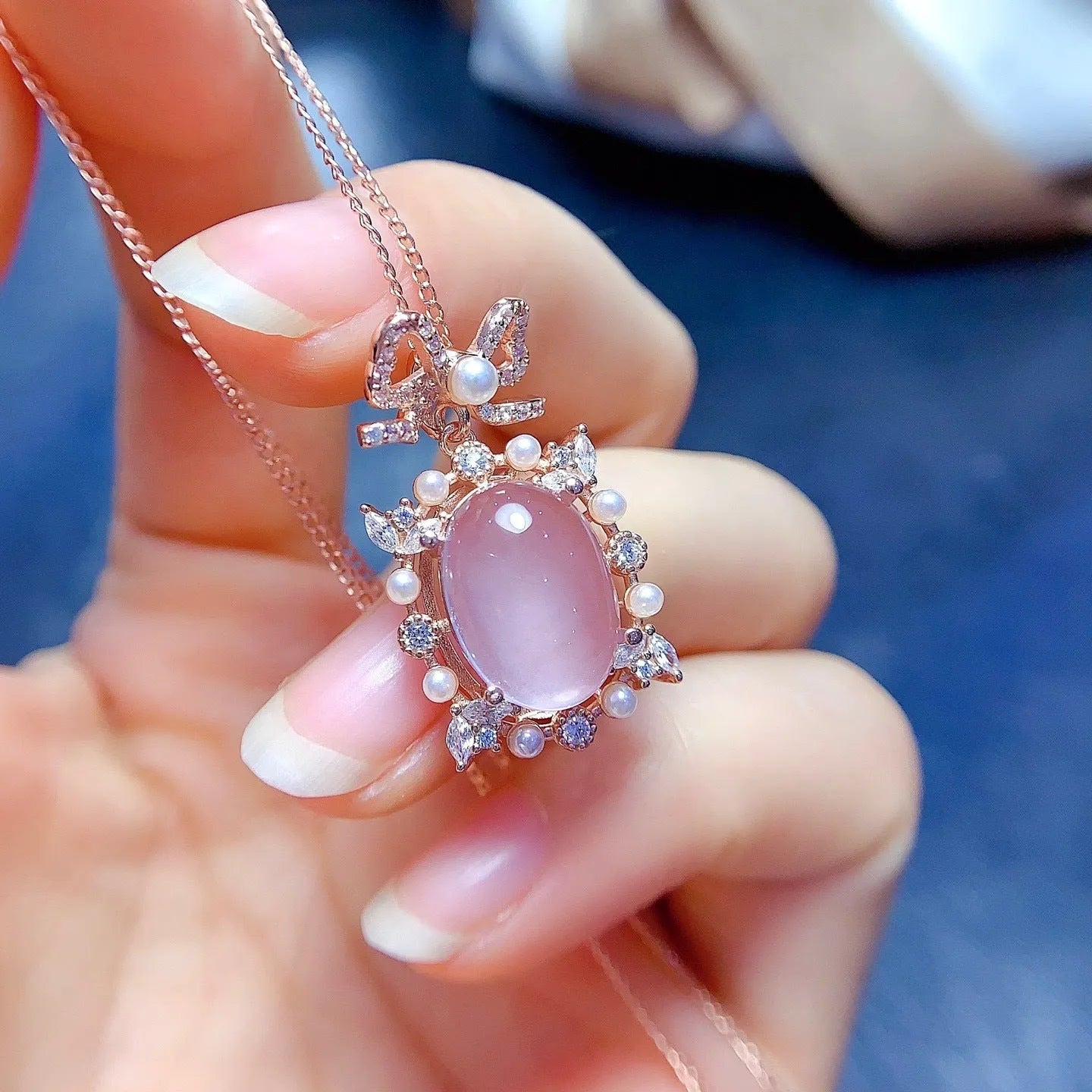 Pink crystal rose quartz pendant with rose gold plated geometric setting on alloy necklace