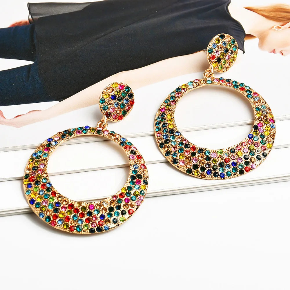 A pair of large round colourful metal pendant earrings in a cartoon style for women.