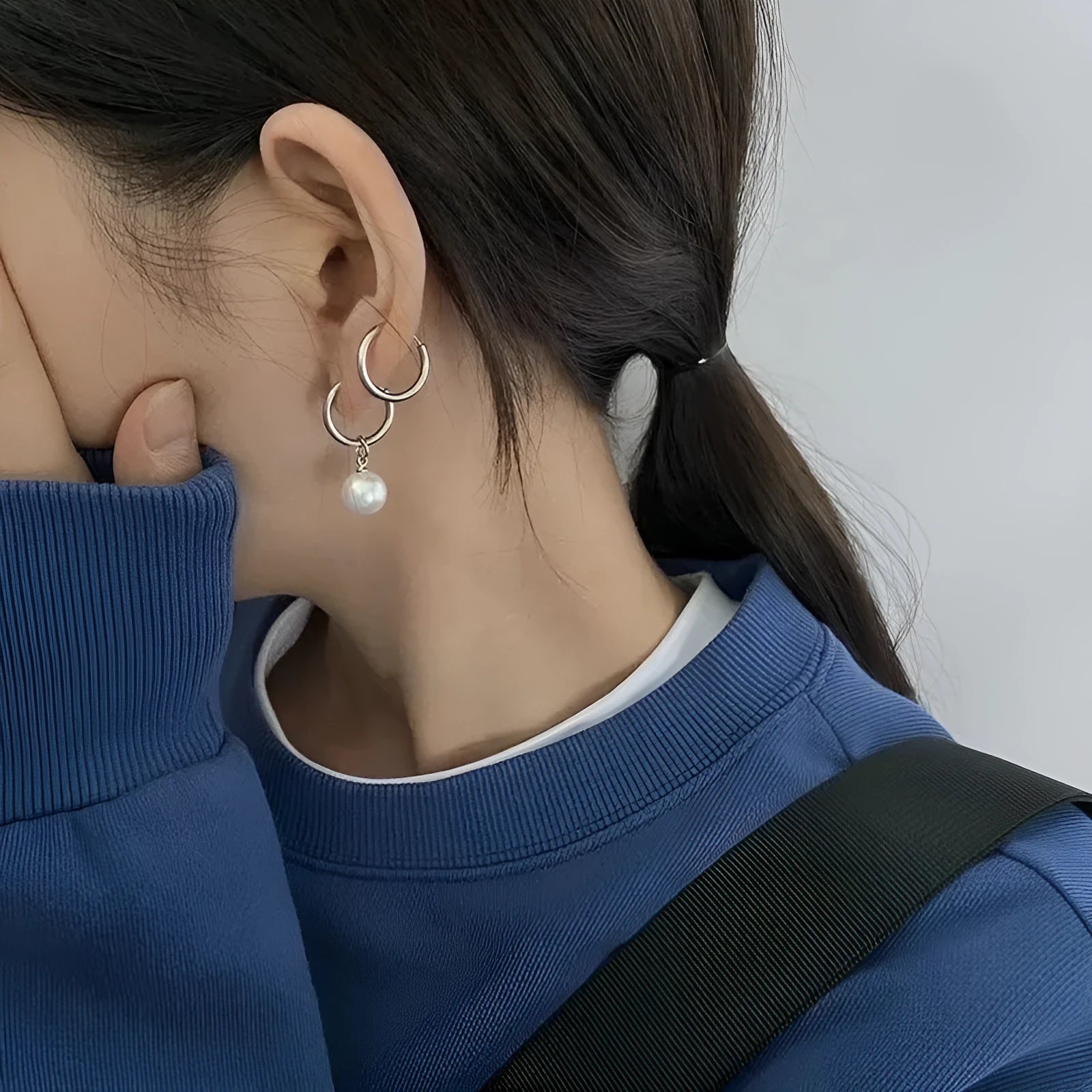 A pair of women's geometric drop earrings with a round pearl detail on alloy hooks.