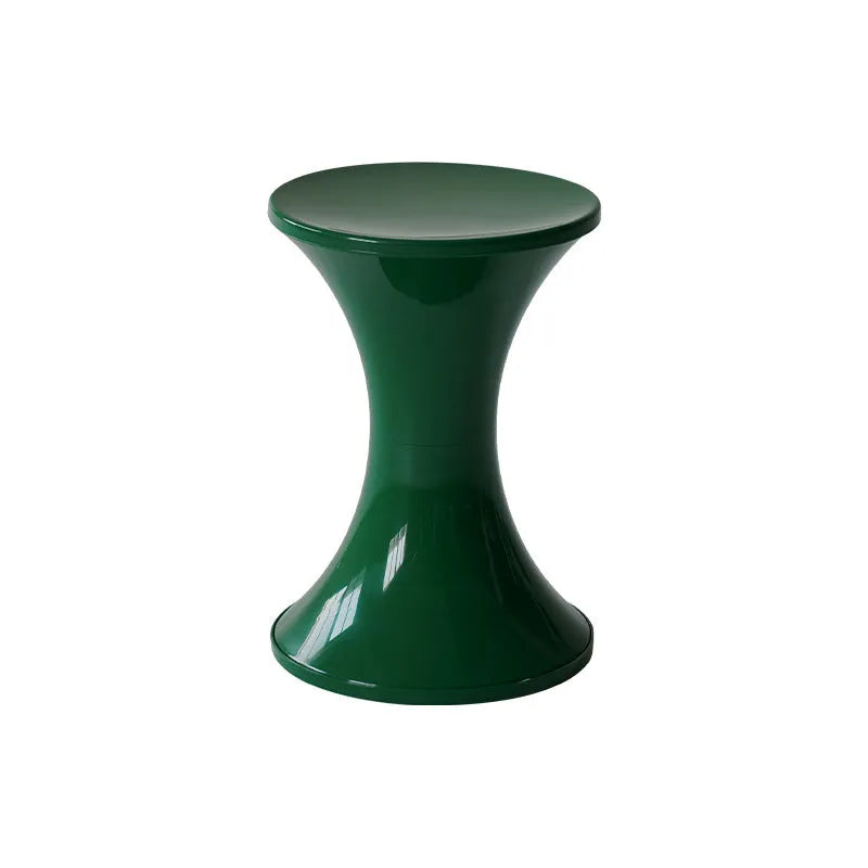 Green plastic hourglass style shoe changing stool on a wooden floor